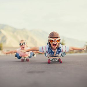 Children loving riding skateboard, happy with life